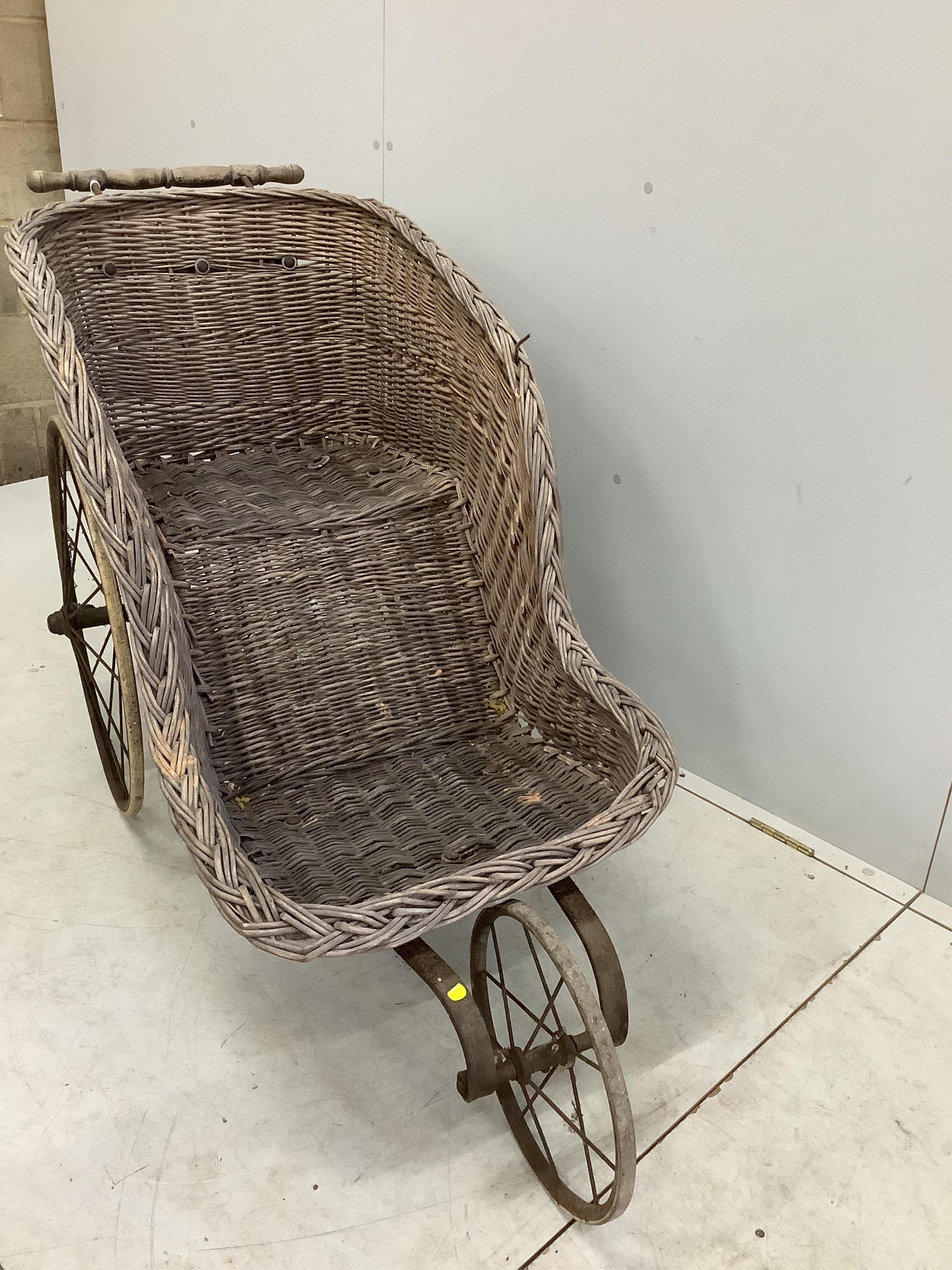 A 19th century wrought iron and wicker invalid's chair, width 60cm, height 88cm. Condition - fair to poor
